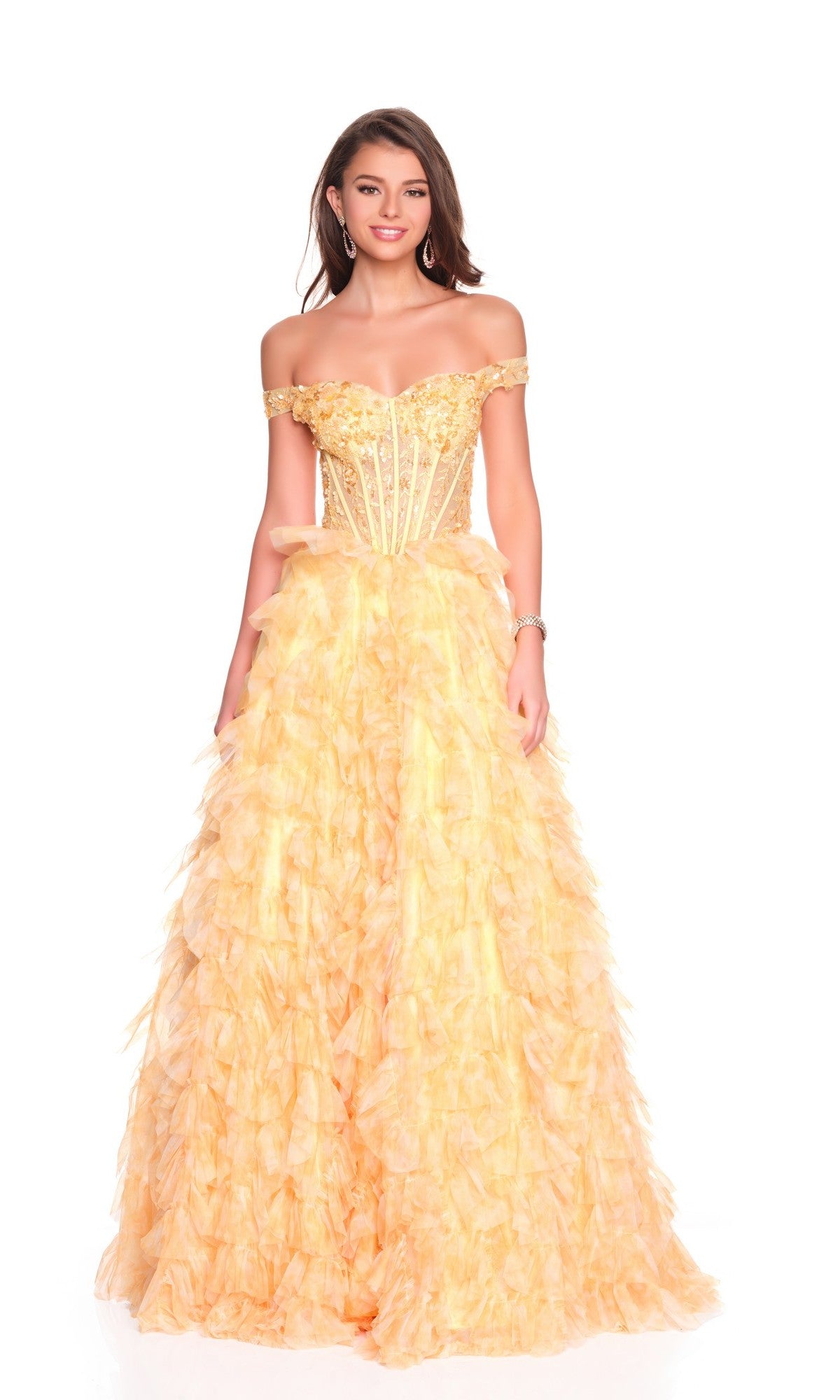 A woman poses in front of a white background wearing the Dave and Johnny 12767 long prom dress in yellow, designed with an off-the-shoulder fitted bodice and a ruffled tulle A-line skirt.